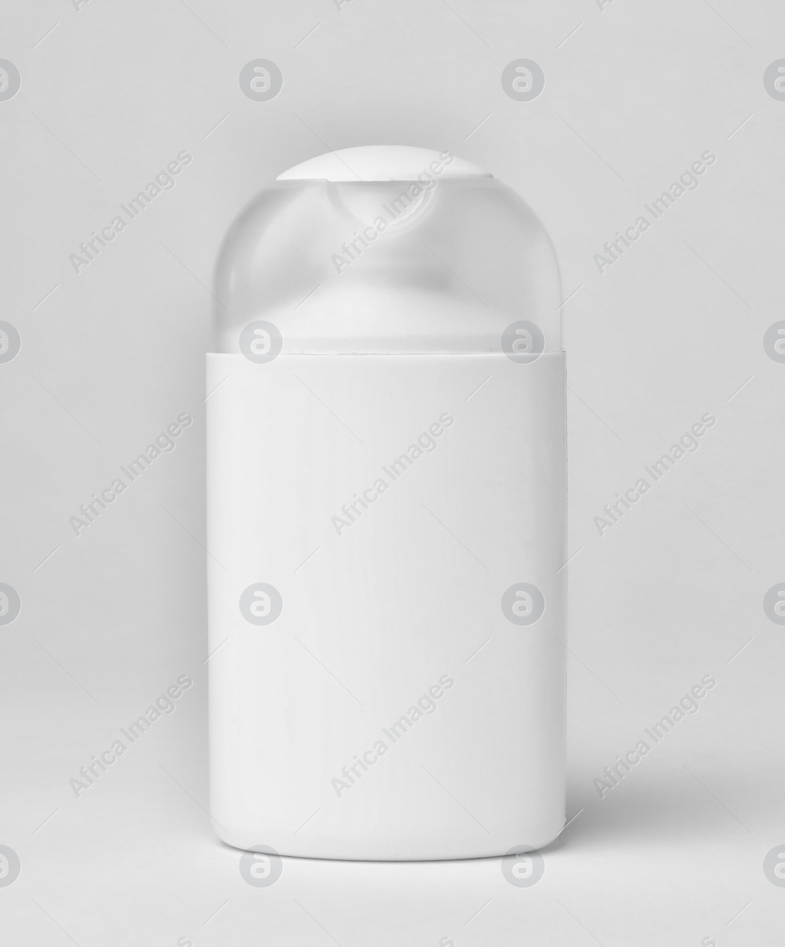 Photo of Bottle of cosmetic product on light background