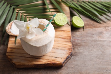 Fresh coconut drink in nut on wooden board