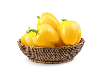 Photo of Wicker bowl of ripe yellow bell peppers isolated on white