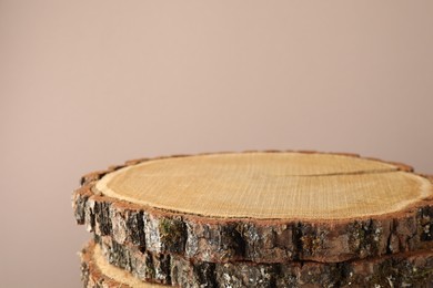 Photo of Presentation for product. Wooden stumps on beige background. Space for text