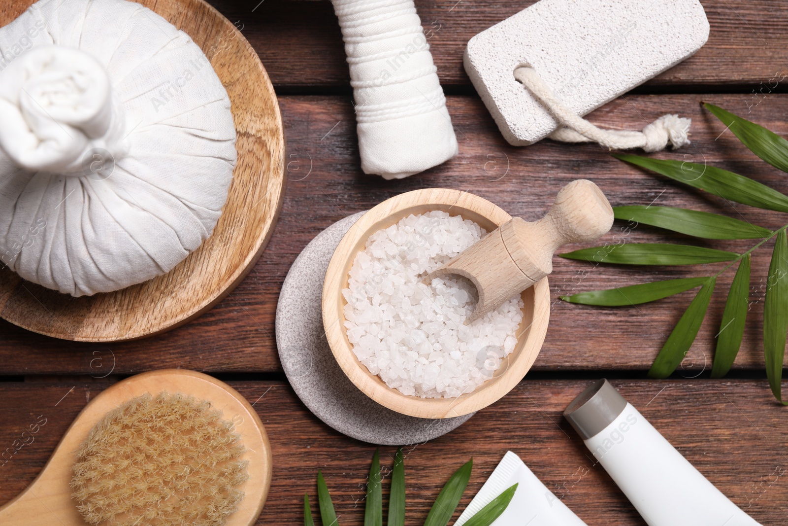 Photo of Flat lay composition with spa products and green leaves on wooden table