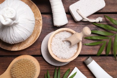 Photo of Flat lay composition with spa products and green leaves on wooden table