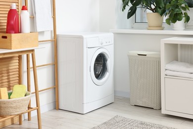 Photo of Laundry room interior with washing machine and furniture