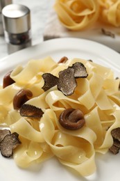 Tasty tagliatelle with truffle on table, closeup