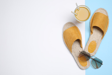 Photo of Stylish shoes, sunglasses and glass of juice on color background, flat lay with space for text. Beach objects