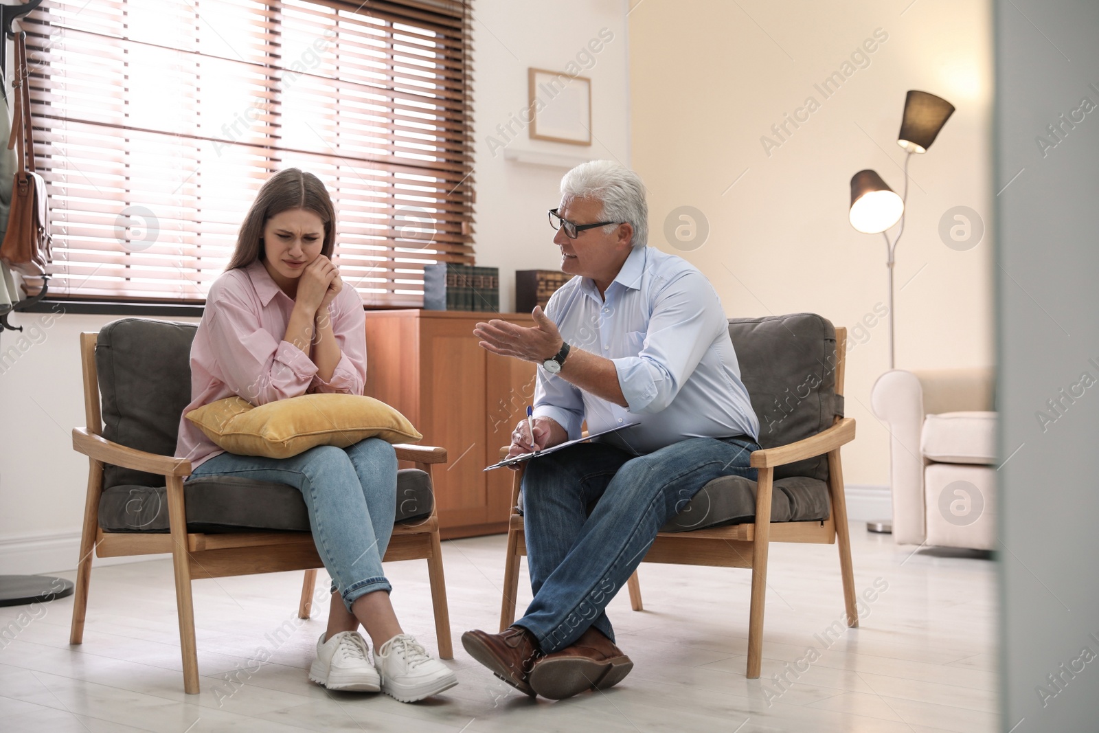 Photo of Professional psychotherapist working with patient in office