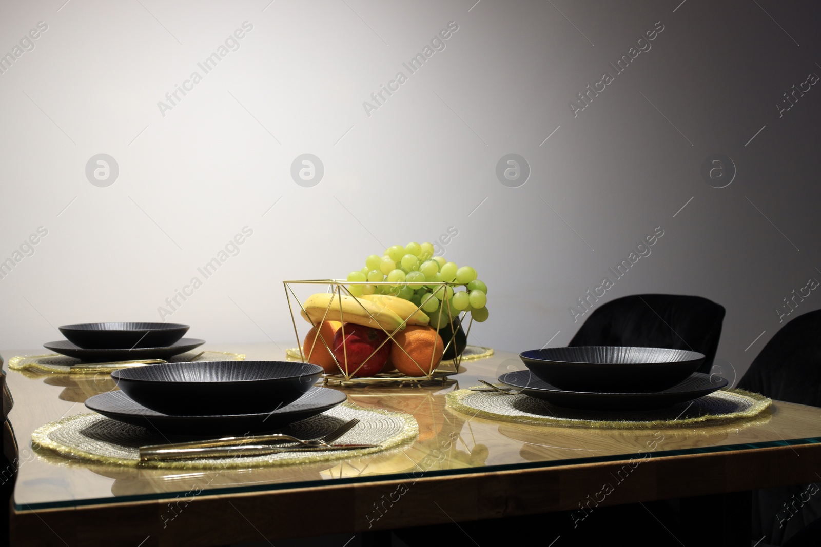 Photo of Table set for dinner near white wall