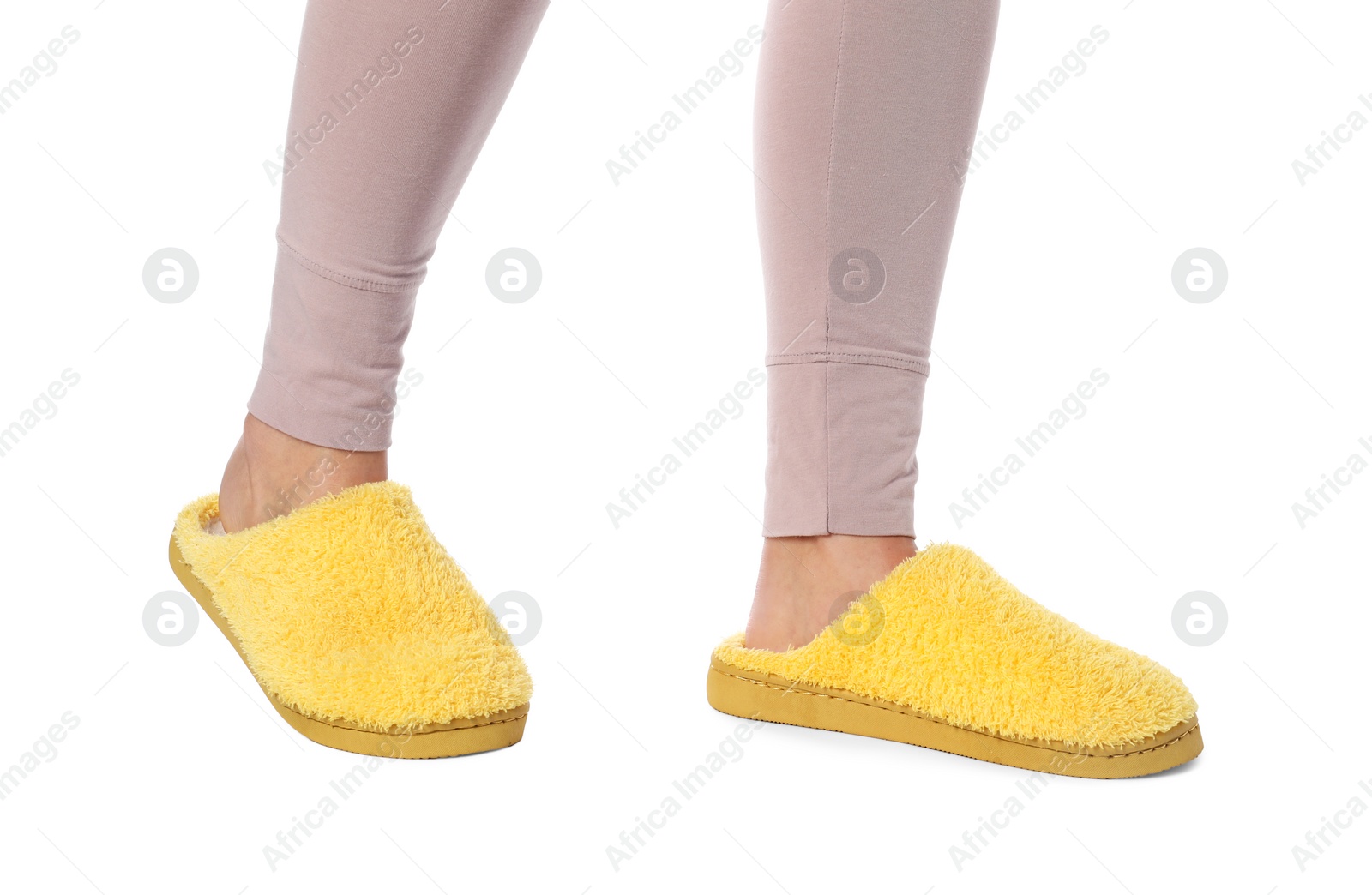 Photo of Woman in yellow soft slippers on white background, closeup