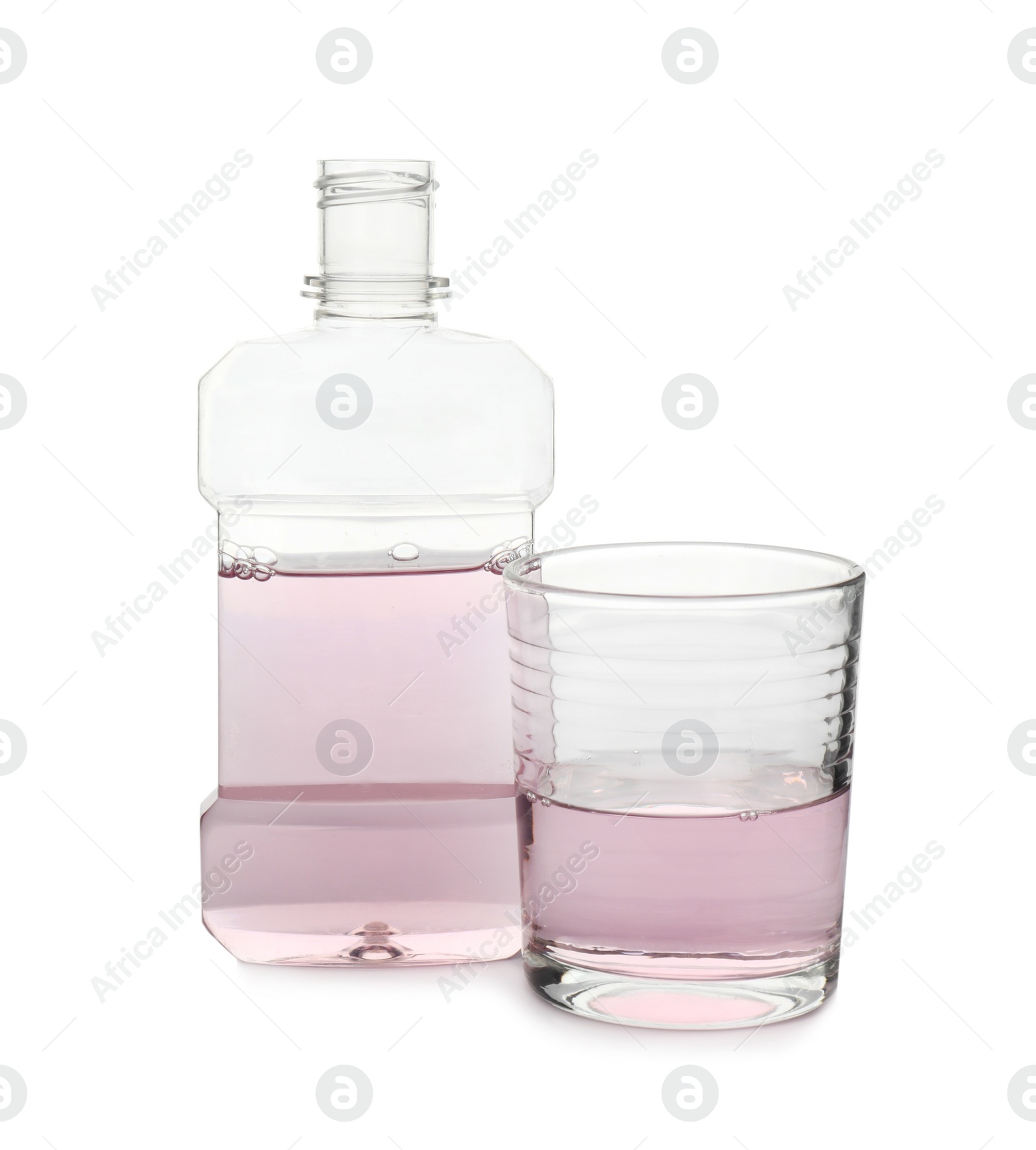 Photo of Bottle and glass with mouthwash on white background. Oral hygiene