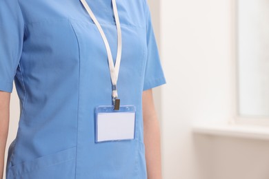 Photo of Doctor with blank badge in hospital, closeup. Space for text