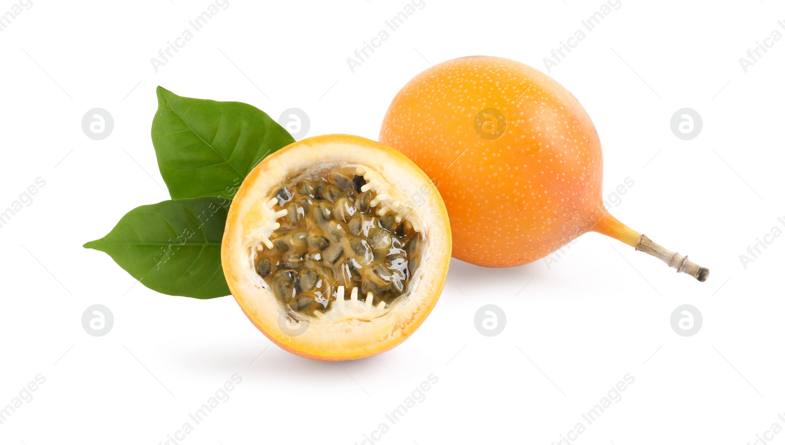 Photo of Whole and cut delicious ripe granadillas with leaves on white background
