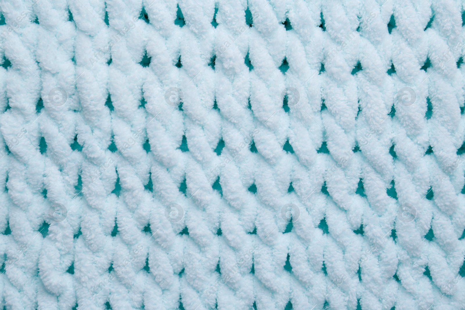 Photo of Soft light blue knitted fabric as background, top view