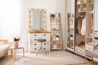 Photo of Elegant room with dressing table and wardrobe. Interior design
