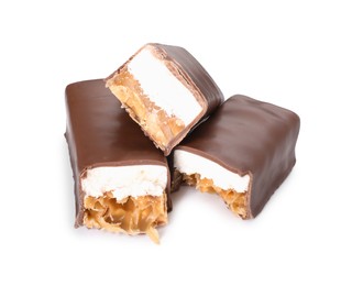 Photo of Pieces of tasty chocolate bars with nougat and nuts on white background