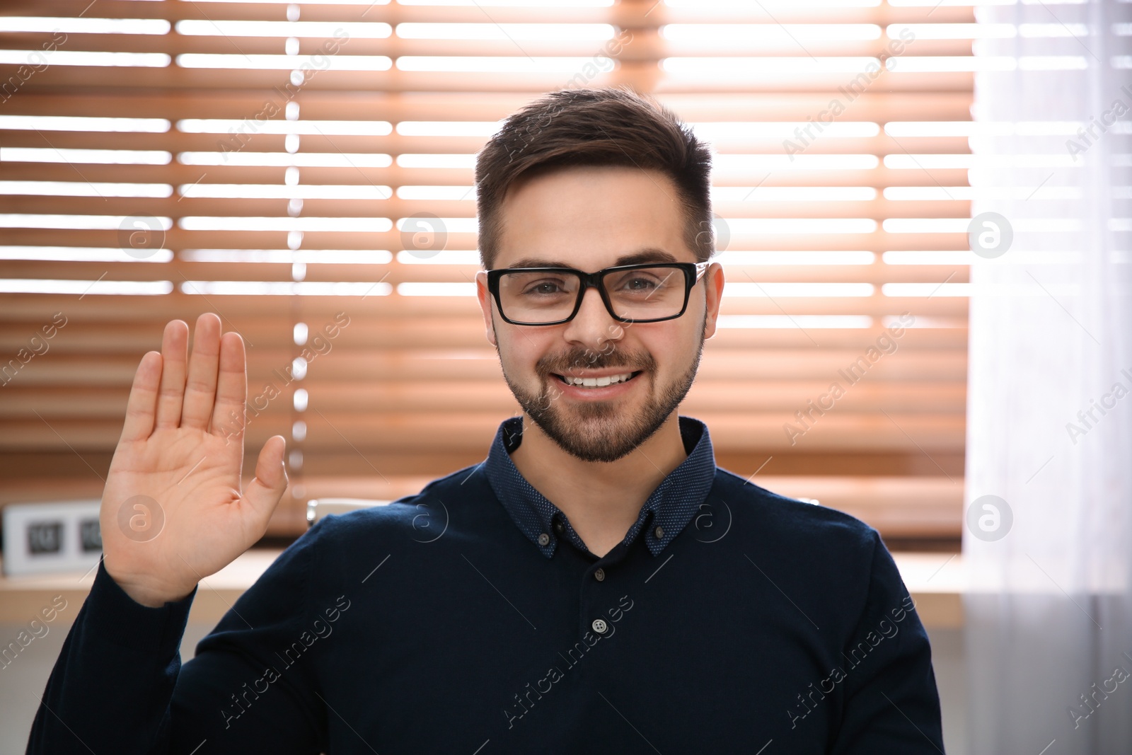 Photo of Happy man using video chat in modern office, view from web camera