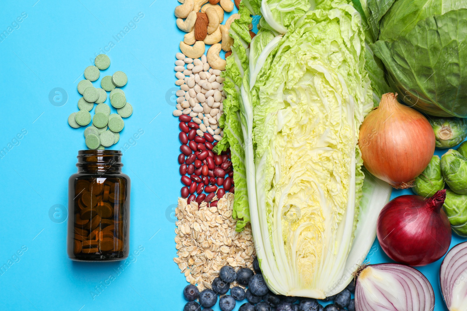 Photo of Bottle with pills and foodstuff on light blue background, flat lay. Prebiotic supplements