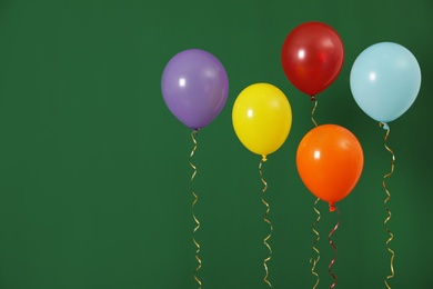 Photo of Bright balloons on color background, space for text. Celebration time