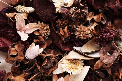 Photo of Aromatic potpourri of dried flowers as background, top view