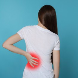 Image of Woman suffering from rheumatism on light blue background