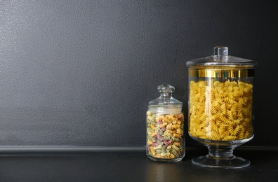 Products in modern kitchen glass containers on black table. Space for text