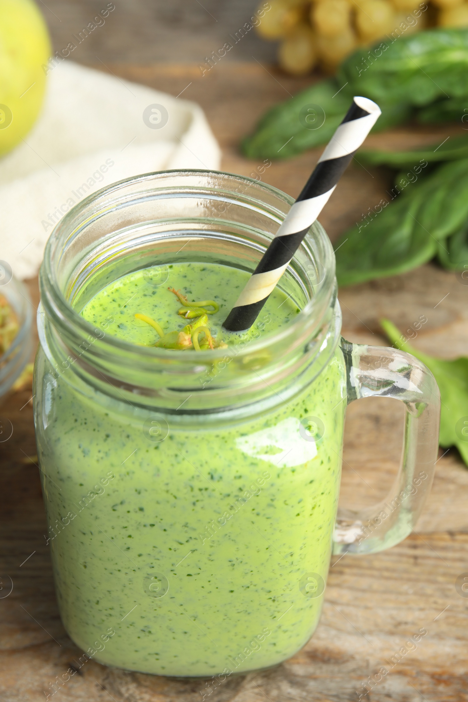 Photo of Tasty green buckwheat smoothie on wooden table