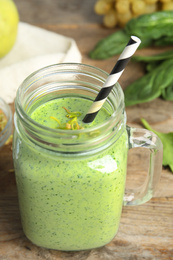 Tasty green buckwheat smoothie on wooden table