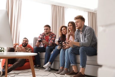 Emotional friends playing video games at home