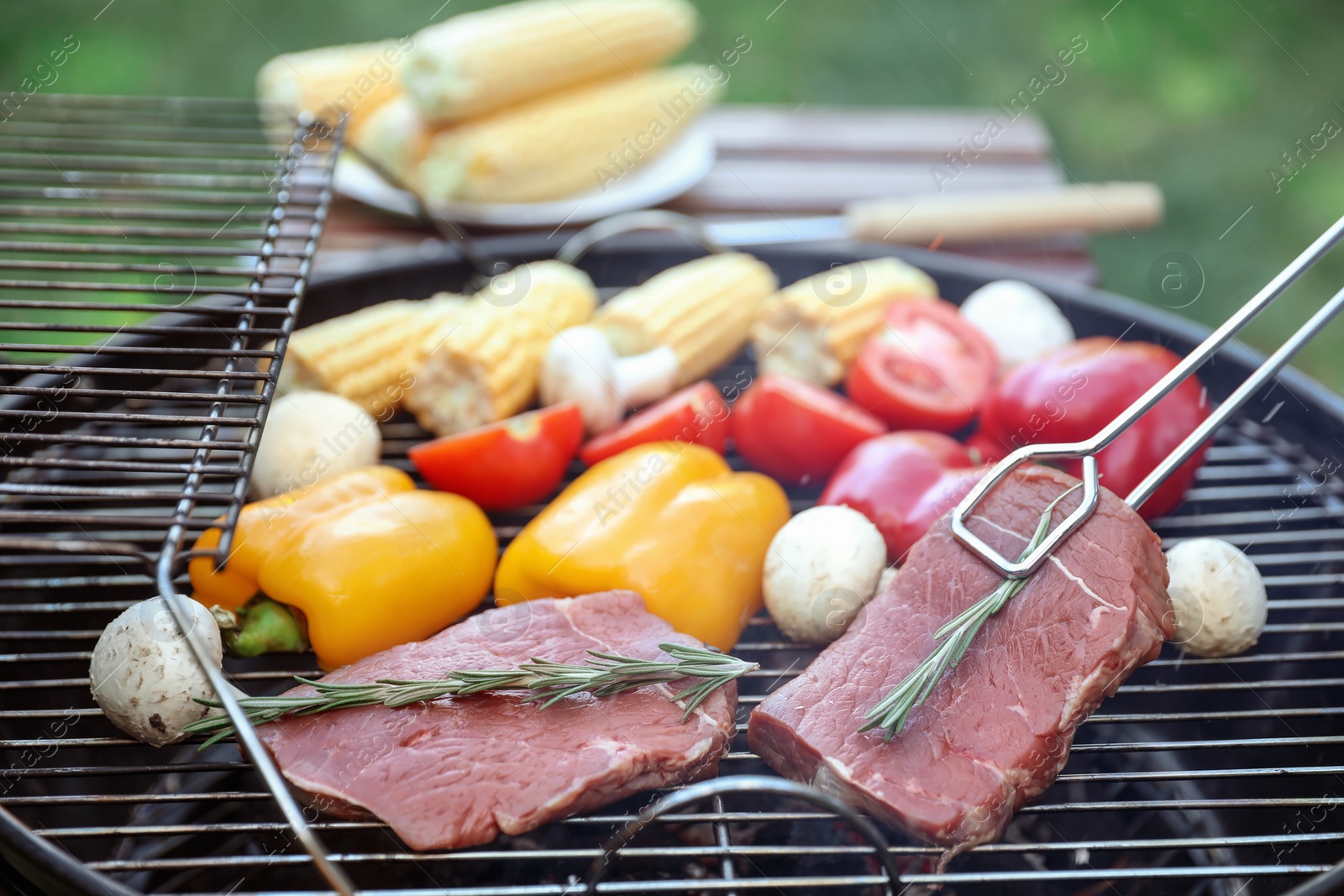 Photo of Cooking fresh food on barbecue grill outdoors, closeup