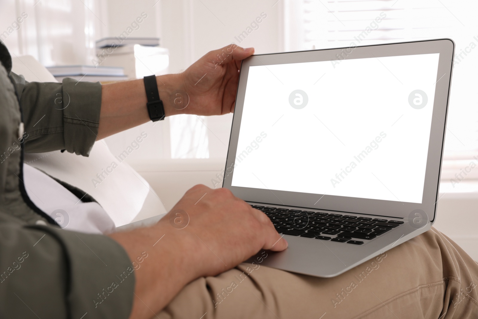 Photo of Man with modern laptop indoors, closeup. Space for design