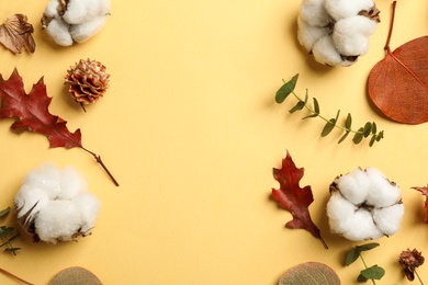 Photo of Flat lay composition with cotton flowers on yellow background. Space for text