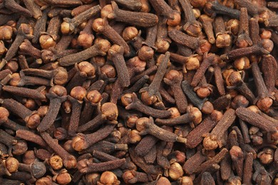 Aromatic dry cloves as background, top view