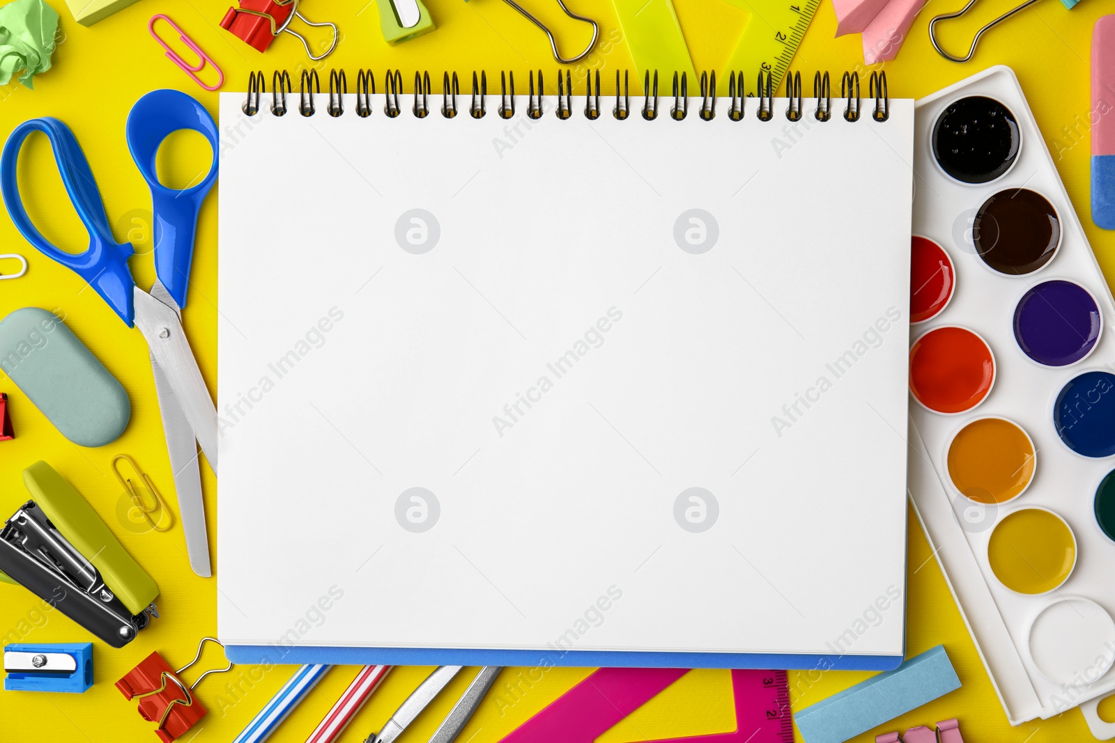 Photo of Flat lay composition with different school stationery on yellow background, space for text. Back to school