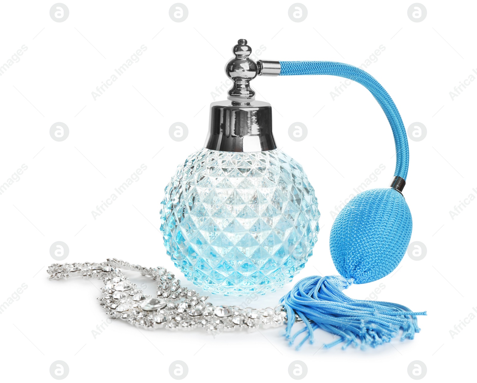 Photo of Glass bottle of perfume and luxury jewellery isolated on white