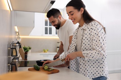 Happy lovely couple cooking together in kitchen