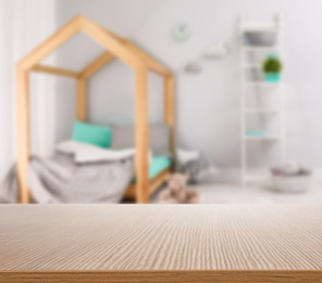 Image of Empty wooden table in baby room interior