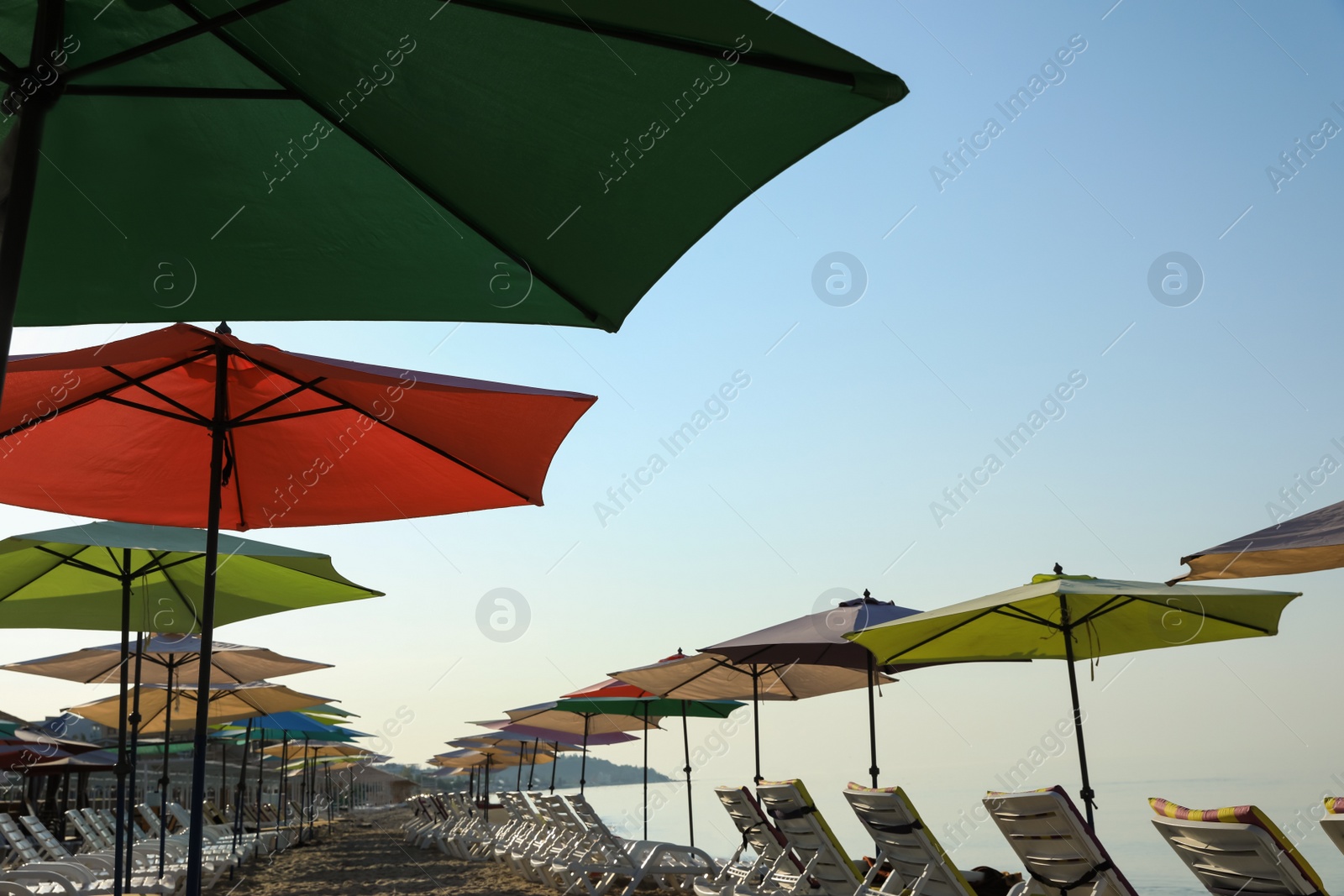 Photo of Many beach umbrellas and sunbeds at resort
