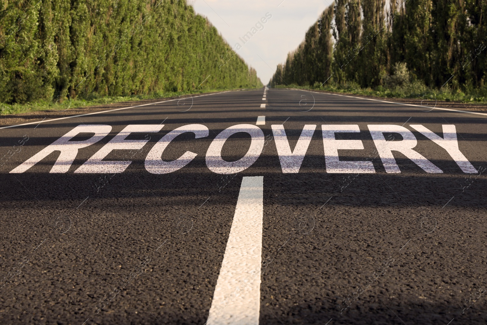 Image of Start to live without alcohol addiction. Word RECOVERY on asphalt highway