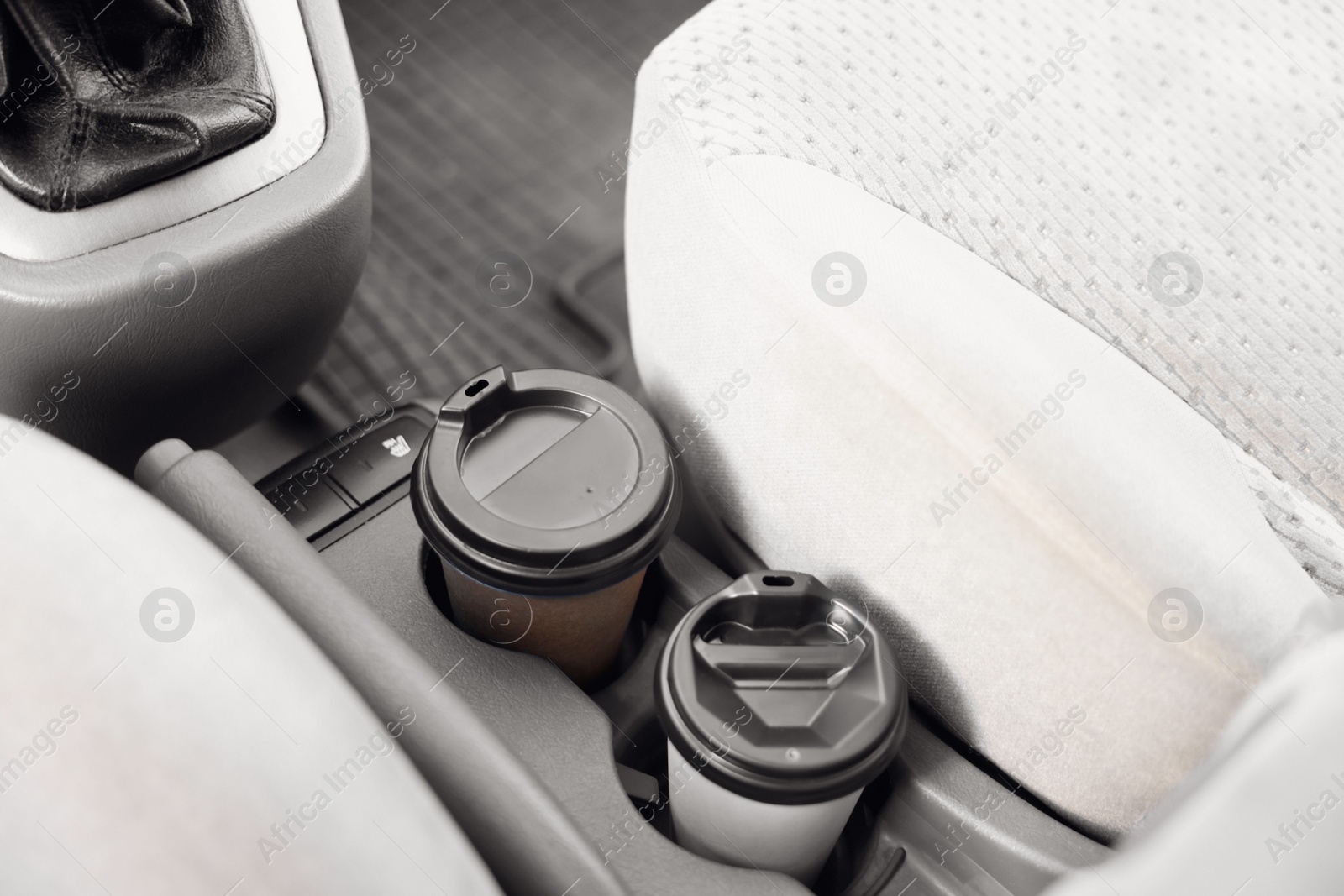 Photo of Coffee to go. Paper cups with tasty drink in holder inside of car
