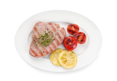 Photo of Delicious tuna steak with tomatoes and lemon isolated on white, top view