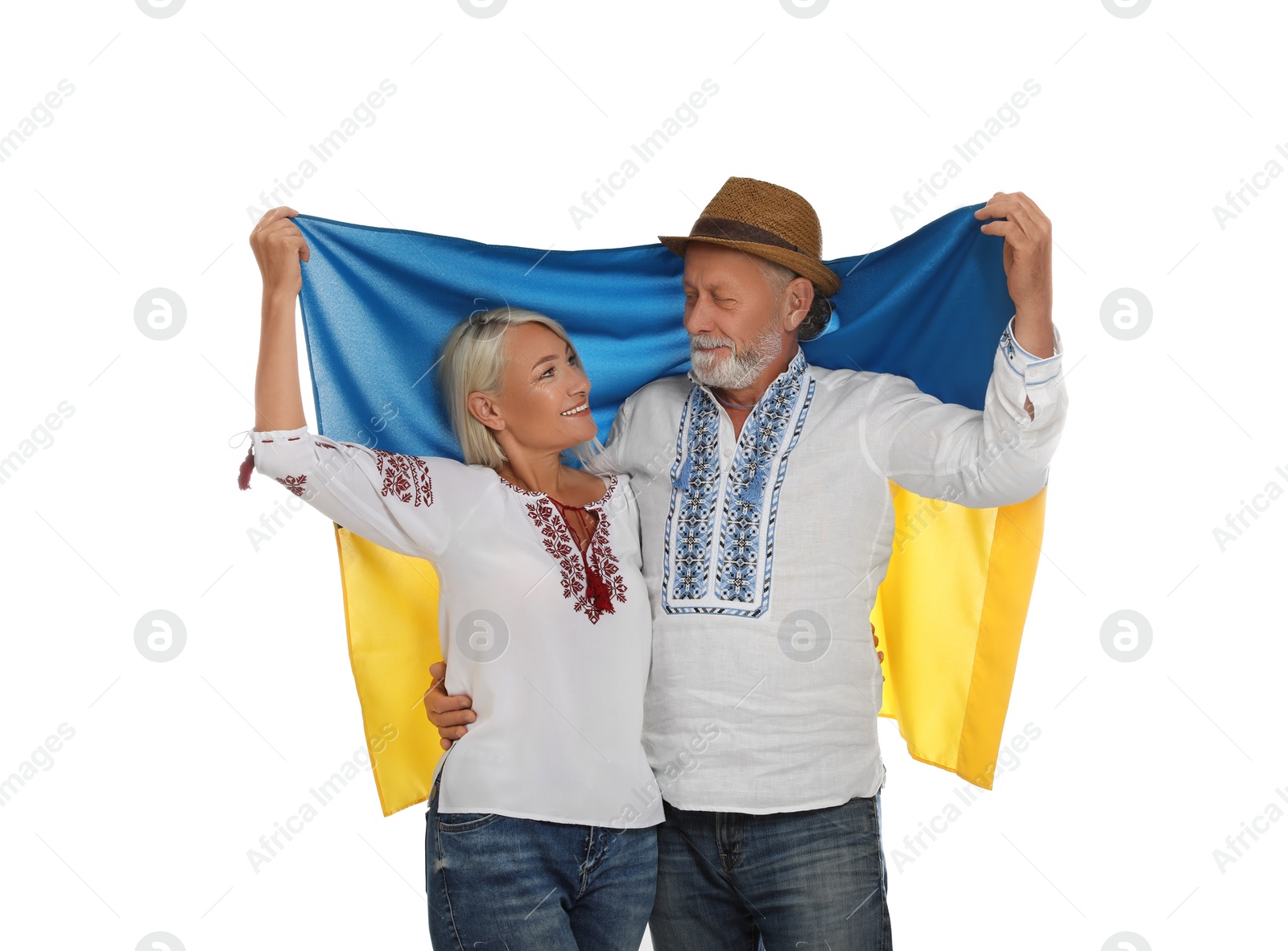 Photo of Happy mature couple with national flag of Ukraine on white background