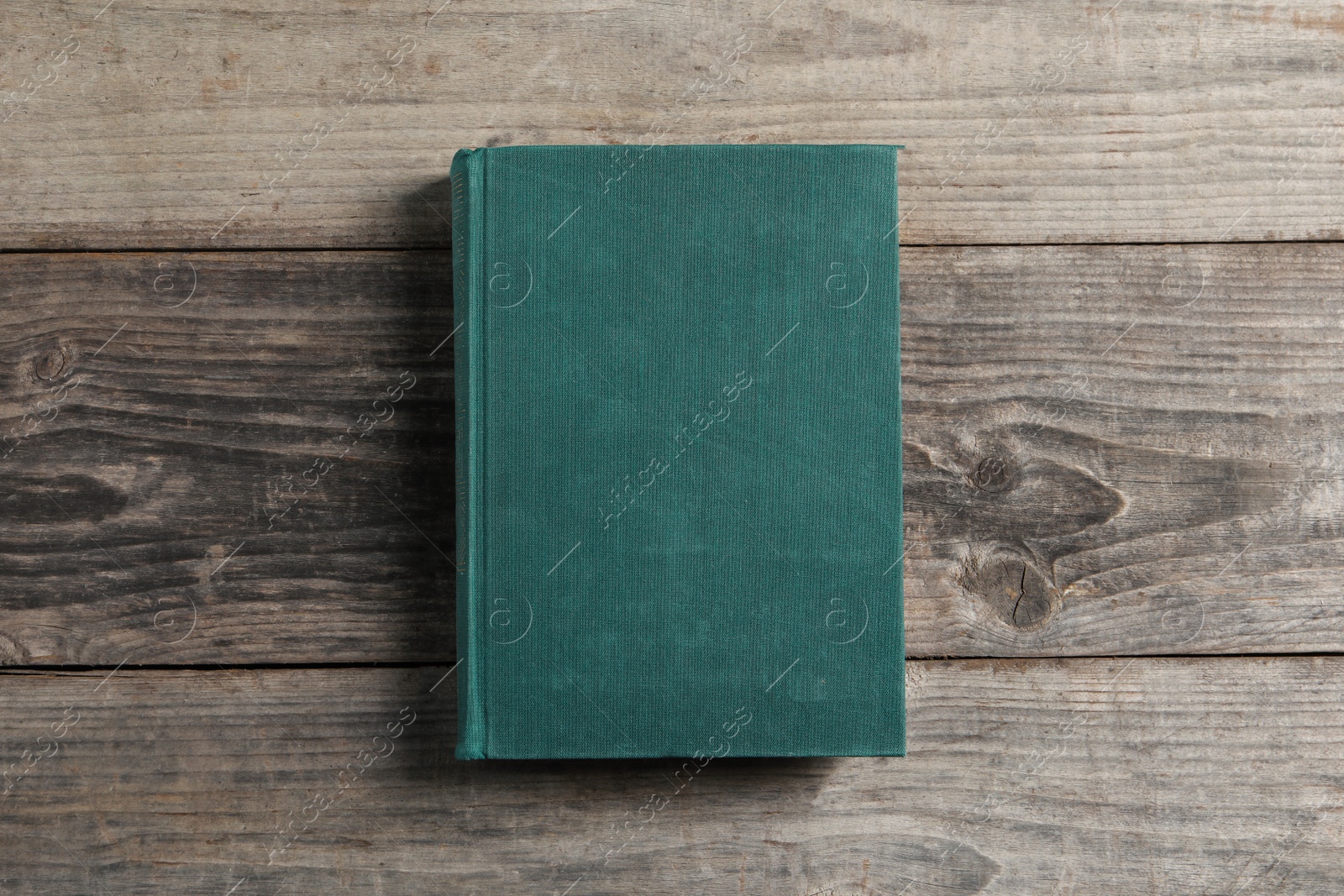 Photo of Old hardcover book on grey wooden table, top view