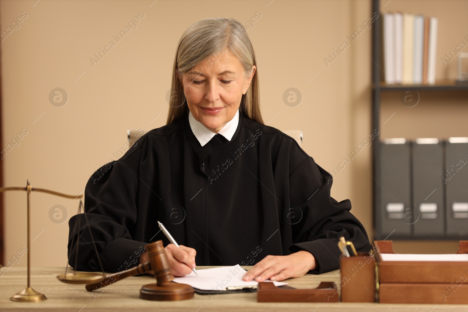 Photo of Judge working with document at table indoors