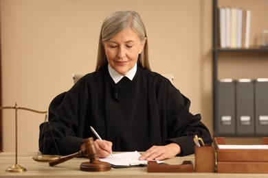 Photo of Judge working with document at table indoors