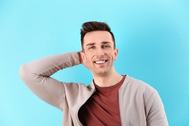 Charming young man on color background