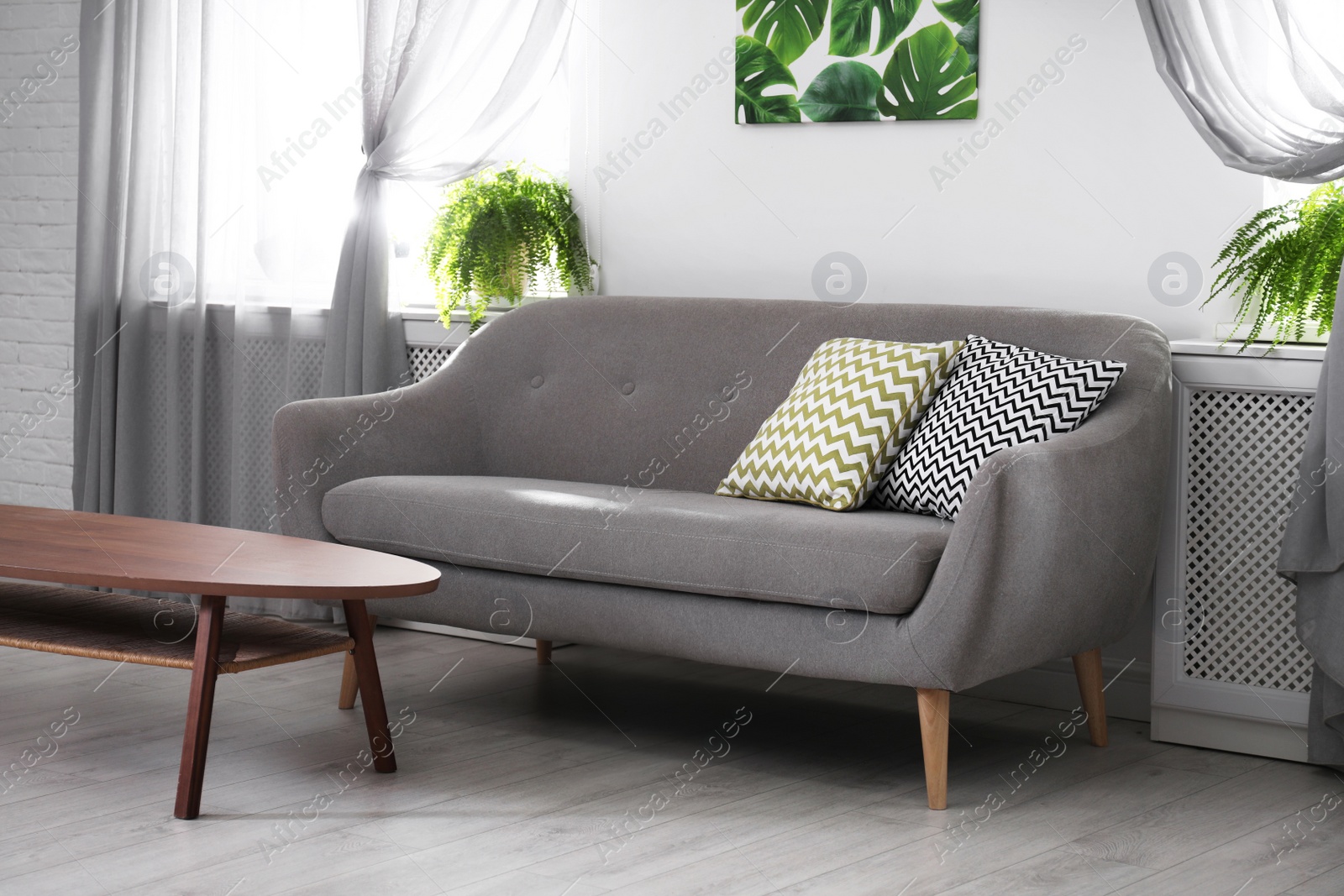 Photo of Modern comfortable sofa in stylish home interior