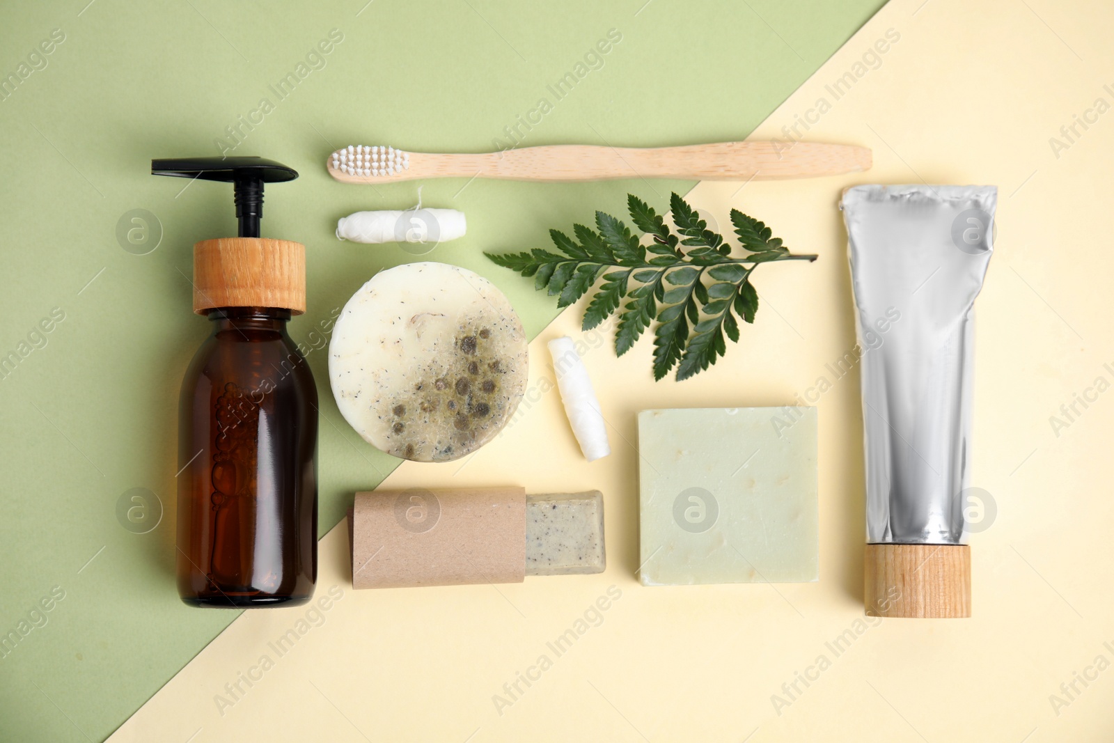 Photo of Eco friendly personal care products and green leaf on color background, flat lay