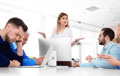 Office employees having argument during business meeting