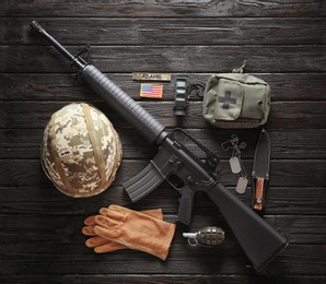 Photo of Set of military outfit on dark wooden background, flat lay