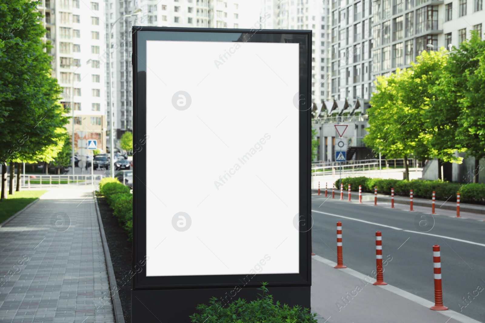 Photo of Blank advertising board on city street. Mockup for design