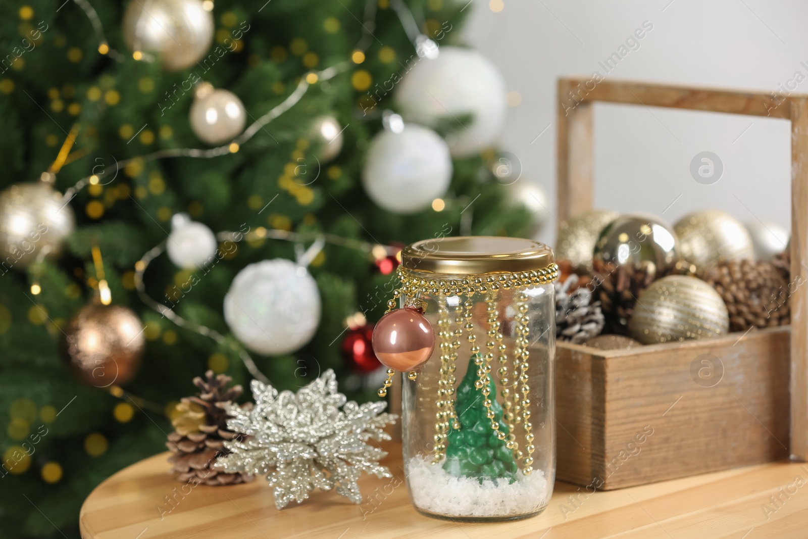 Photo of Handmade snow globe and Christmas decorations on wooden table